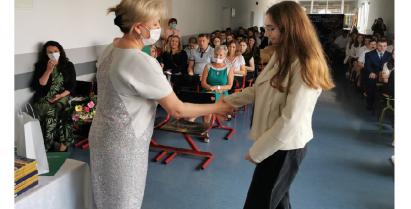 Dyrektor szkoły Małgorzata Krawczyk Figlarz składa gratulacje uczennicy 